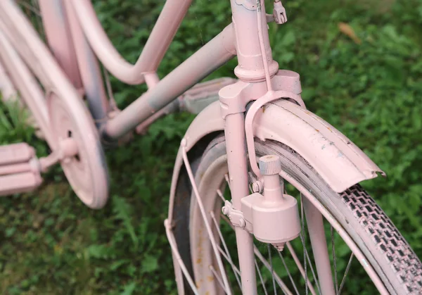 detail of old bicycle with the bottle dynamo on the front wheel