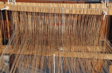 ancient textile loom for weaving of yarns of cotton and wool clipart