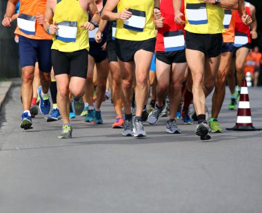 Runners during the Marathon in the city street clipart