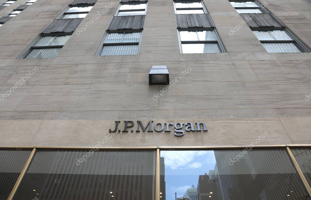New York, NY, USA - August 24, 2025: JP Morgan Skyscraper entrance featuring a large sign viewed from below in Manhattan