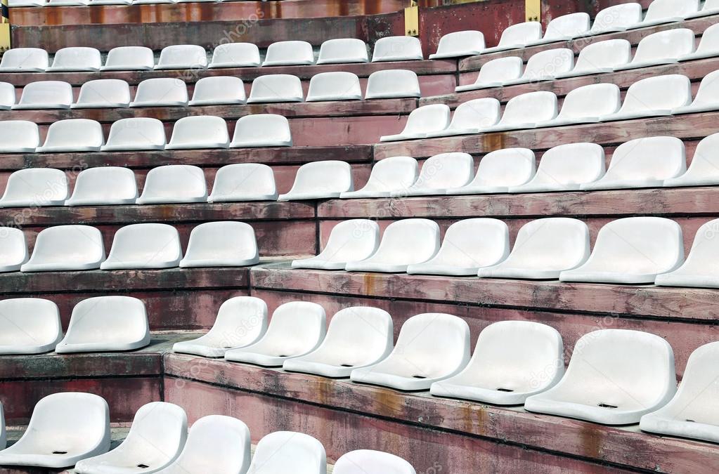 white chairs in empty stands of a modern Stadium