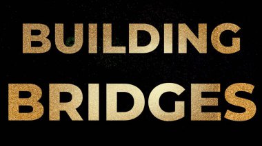 Büyük altın harflerle yazılan köprüler koyu siyah bir zemin üzerinde parlak metalik bir görünüme sahip.