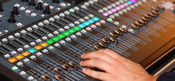 Hand of a man with potentiometers and sound equalizer — Stock Photo, Image