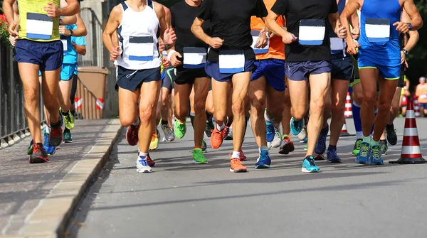 stock image runners in the marathon race on the road into town