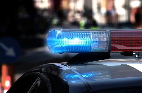Police patrol car with flashing lights and siren on during the n — Stock Photo, Image