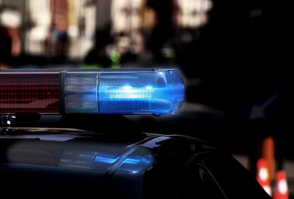 Police patrol car with flashing lights and siren on during the n — Stock Photo, Image