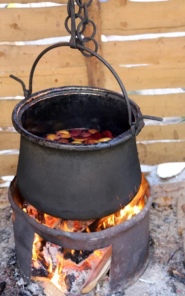 Blackened cauldron to cook the tasty mulled wine in the country — Stock Photo, Image