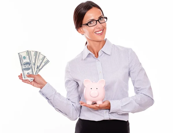 Zakenvrouw holding piggy bank en dollars — Stockfoto