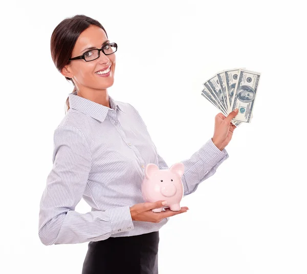 Businesswoman holding piggy bank and dollars — Stock Photo, Image