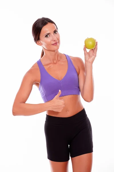 Young fit woman holding an apple — Stock Photo, Image