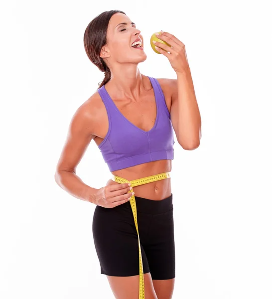 Woman with apple measuring waist — Stock Photo, Image