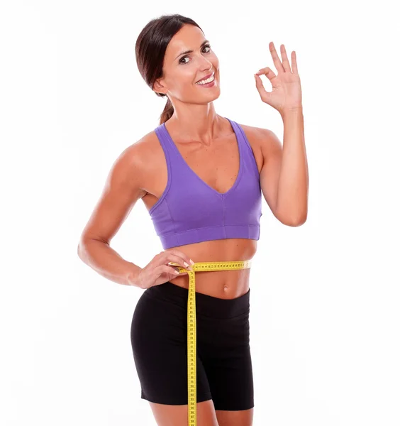 Woman measuring her waist with tape — Stock Photo, Image