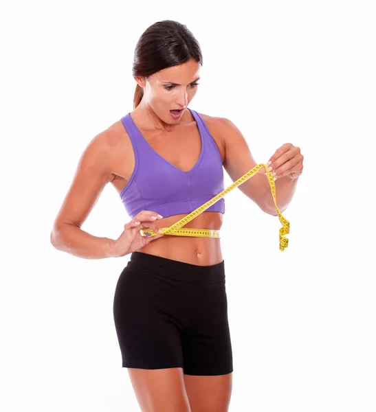 Woman measuring her waist with tape — Stock Photo, Image