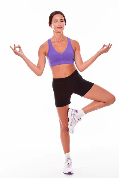 Healthy woman on one leg posing — Stock Photo, Image