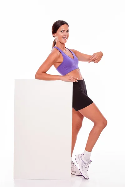 Healthy woman pointing at placard — Stock Photo, Image