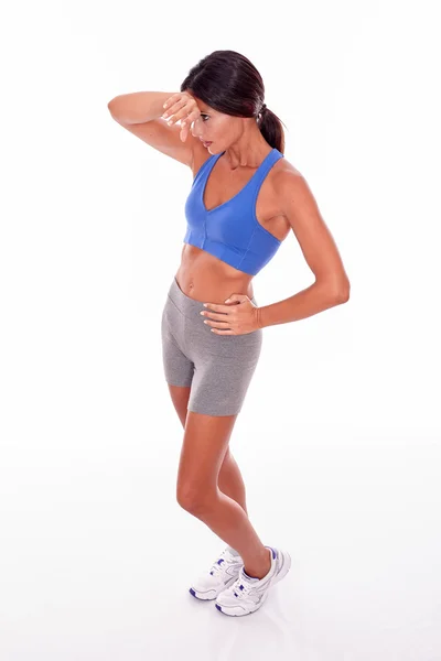 Standing woman wiping her brow — Stock Photo, Image