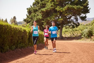 Yarış pisti üzerinde üç tane koşucu