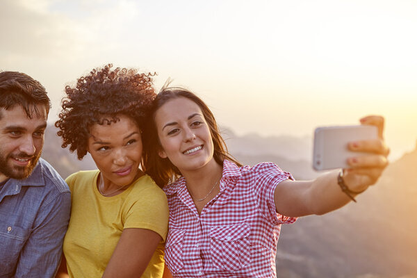 Friends taking selfie on mountain