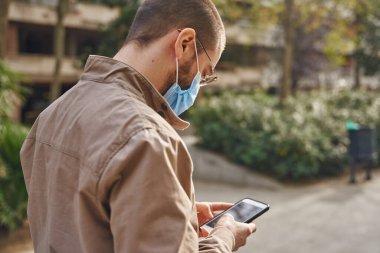 Büyülenmiş bir adam dışarıda duruyor ve bulanık bir geçmişle mesajlaşıyor.