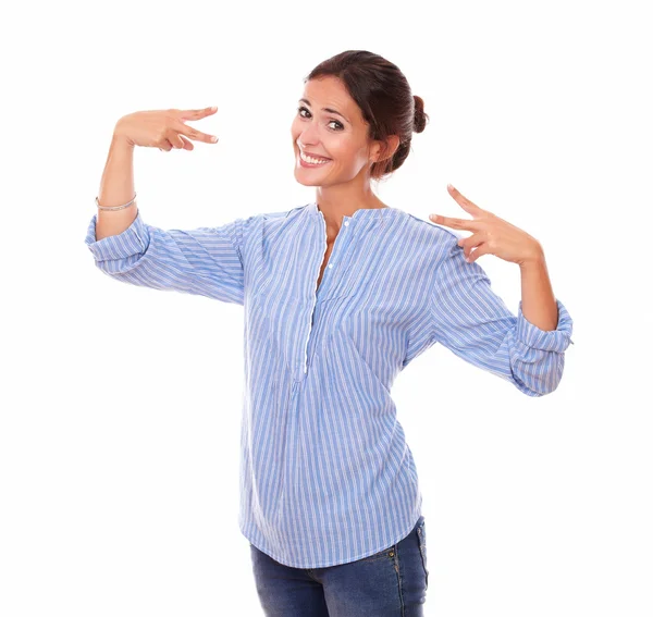 Adult brunette on blue blouse with victory sign Royalty Free Stock Images