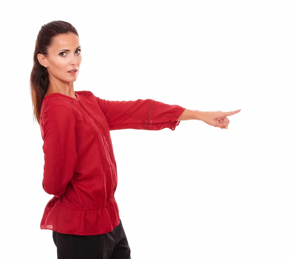 Charming latin woman pointing to her left — Stock Photo, Image