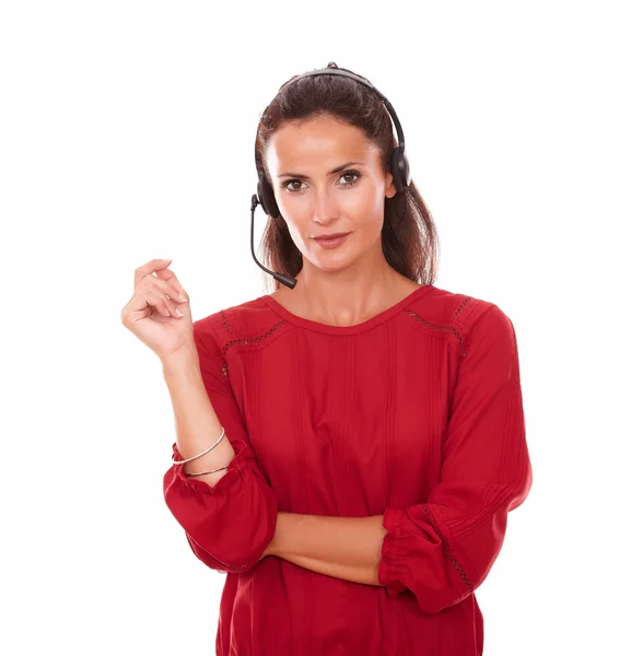 Sexy young woman conversing on earphone — Stock Photo, Image