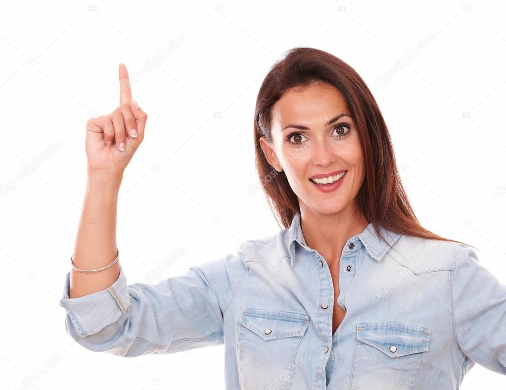 Happy woman on blue shirt pointing up her finger