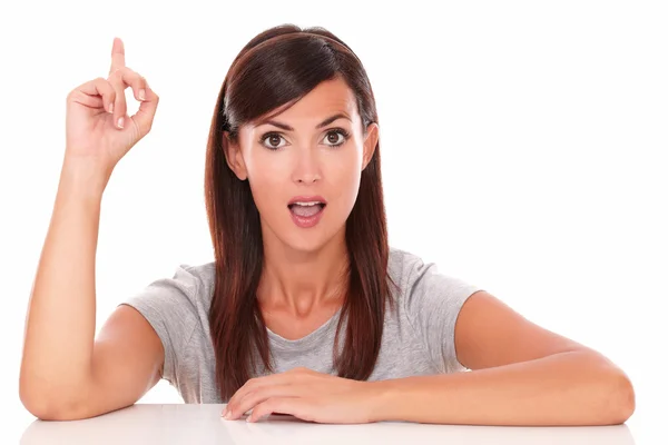 Surprised woman pointing up her finger — Stock Photo, Image