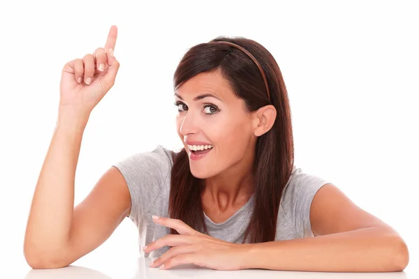 Adult happy female pointing up her finger — Stock Photo, Image