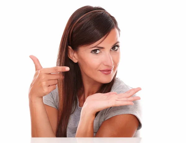 Beautiful woman pointing and holding her palm up — Stock Photo, Image