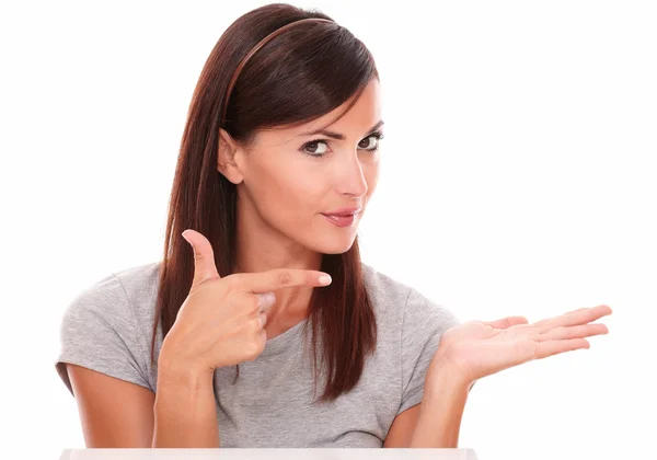 Beautiful woman pointing to her left palm up — Stock Photo, Image