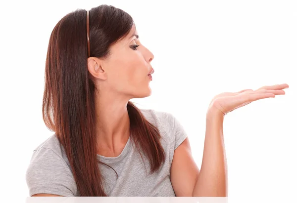 Adult hispanic woman blowing to her left — Stock Photo, Image