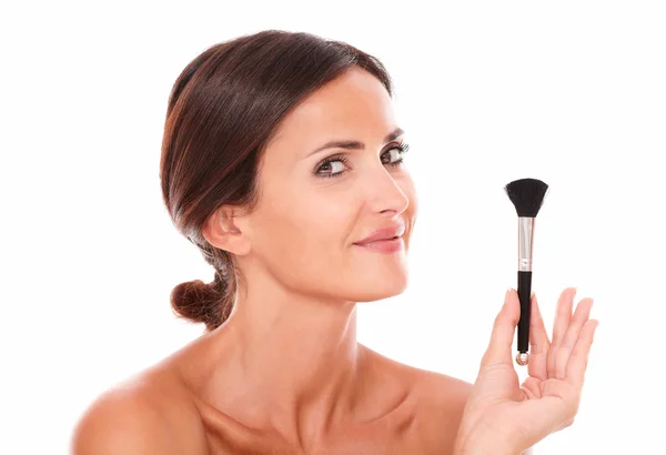 Young woman with make up brush showing her purity — Stock Photo, Image