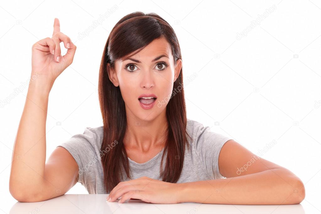 Surprised woman pointing up her finger