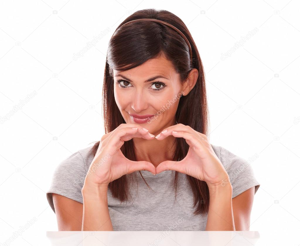 Alone woman with love sign smiling at you