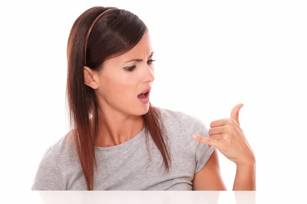 Angry woman with talk gesture looking to her hand — Stock Photo, Image