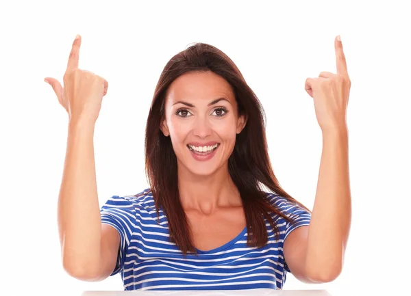 Smiling friendly lady with fingers pointing up — Stock Photo, Image