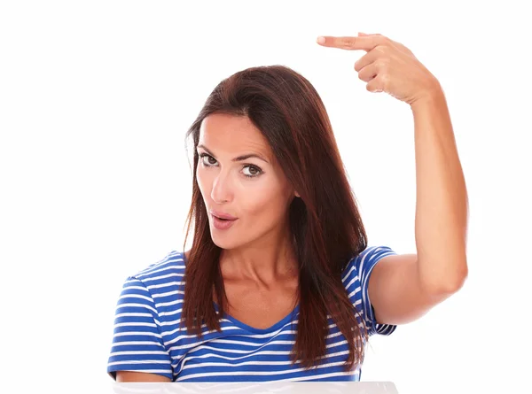 Attractive girl pointing to her right — Stock Photo, Image