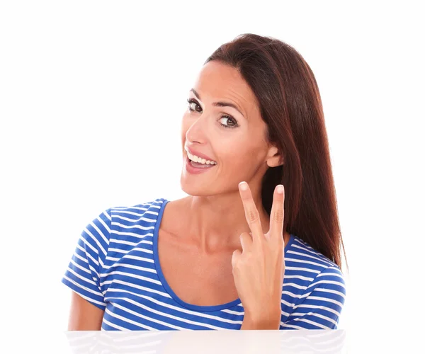 Lächelnde junge Frau mit erhobenen Fingern — Stockfoto