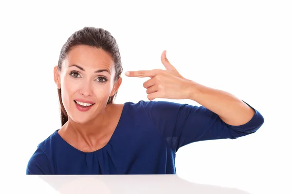 Smiling young brunette gesturing a headshot — Stock Photo, Image