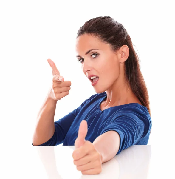 Young lady gesturing shooting a thumb up — Stock Photo, Image