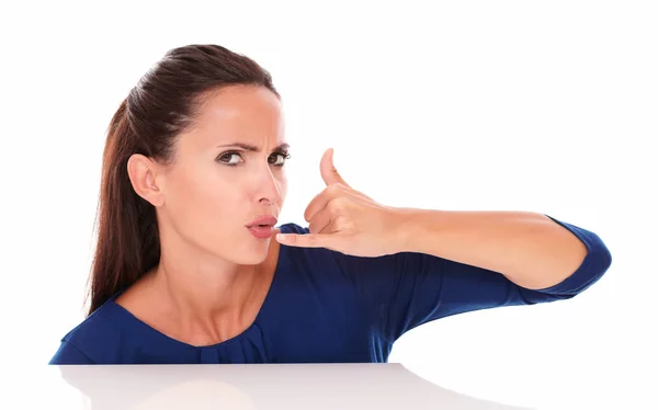 Angry woman in blue shirt gesturing a call — Stock Photo, Image