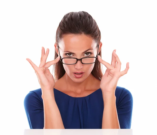 Sexy woman with hand on glasses looking at you — Stock Photo, Image