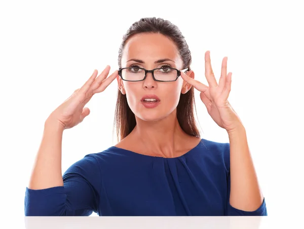 Pretty girl with hand on glasses looking at you — Stock Photo, Image