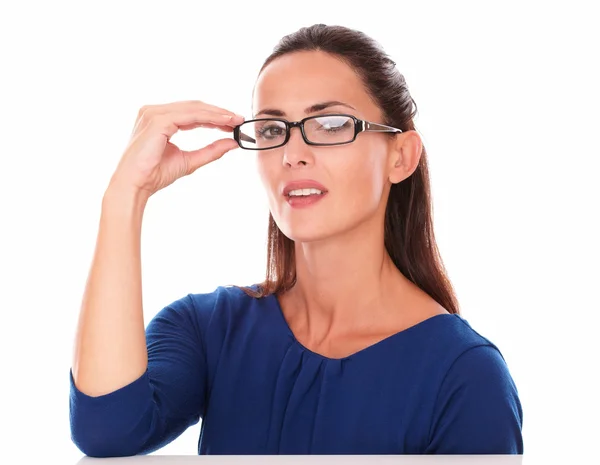 Pretty lady with hand on glasses looking at you — Stock Photo, Image