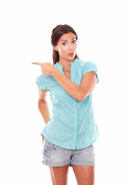 Lovely latin woman pointing to her right — Stock Photo, Image