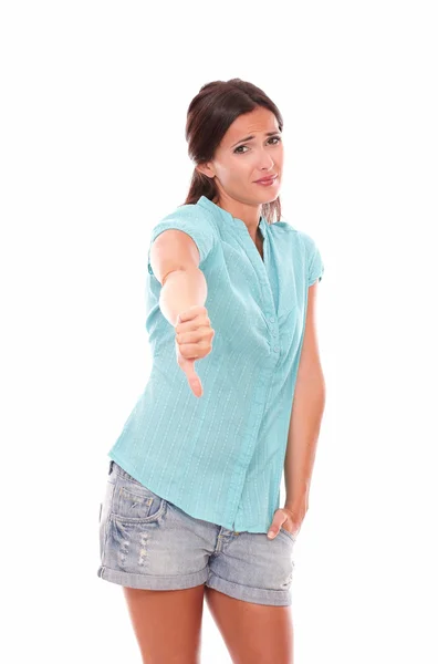 Unhappy woman in short jeans with thumb down — Stock Photo, Image