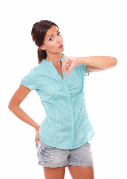 Sad girl in short jeans with thumb down — Stock Photo, Image