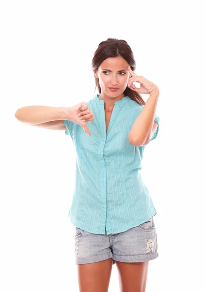 Pensive lady in short jeans with thumb down — Stock Photo, Image