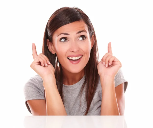 Lovely brunette pointing and looking up — Stock Photo, Image